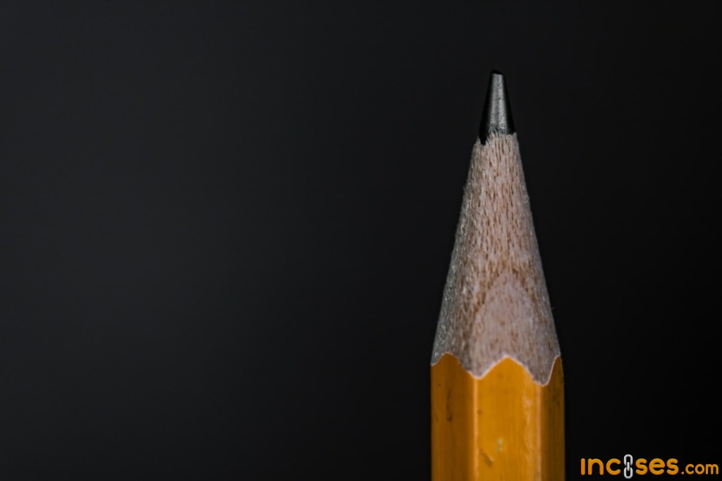 yellow and black pencil on black background